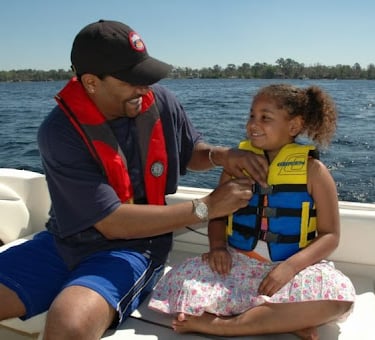 a man and a little girl in life jackets