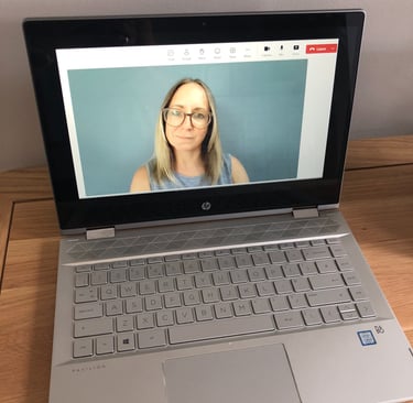A laptop showing Emily dialled into a vide call