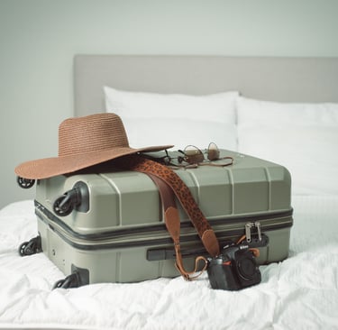 a hat and suitcase lying on bed of a hotel in costa rica