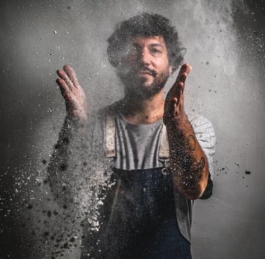 a chef wearing a apron throwing floor in the air