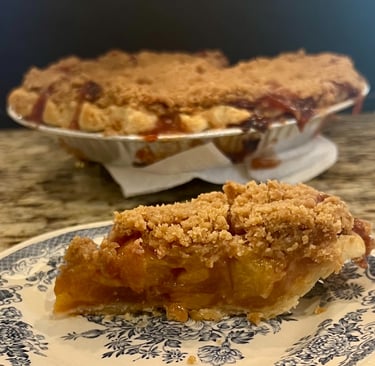 slice of peach pie with crumb top
