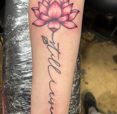 a tattoo of a lotus flower on a woman's arm