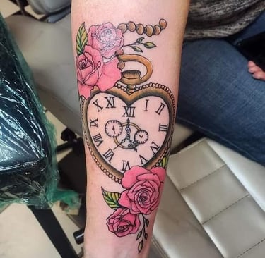a clock on a wrist tattoo of a heart shaped clock