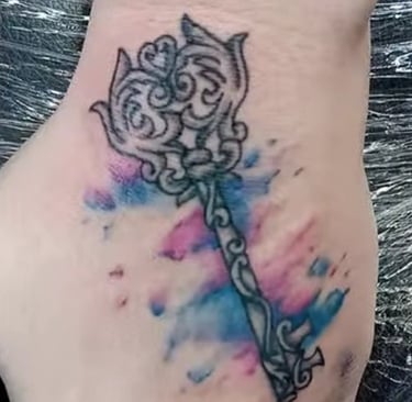 a tattoo style key water color on a hand