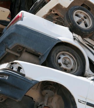 Junk cars stacked three high.