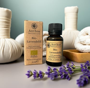 a box and a bottle of lavender essential oil and lavender flowers