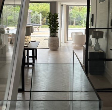 A light oak herringbone floor running throughout an open plan house