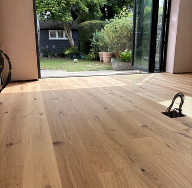 An oak plank floor in a kitchen extension with bifolding doors
