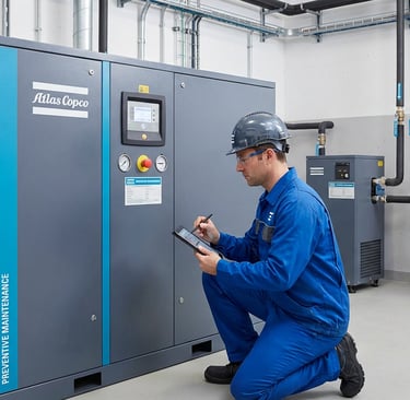 technician performing preventive maintenance on industrial air compressor
