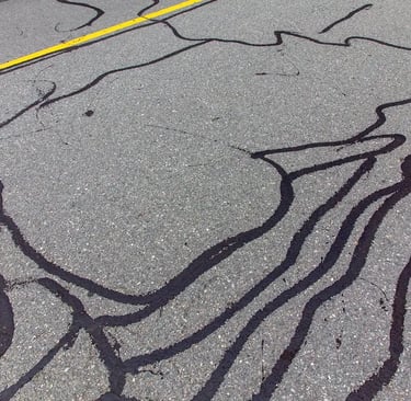 Sealing cracks using professional machinery, expanding the longevity of the asphalt