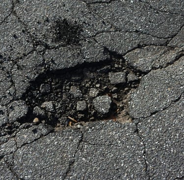 Crumbled pothole example that needs repaired