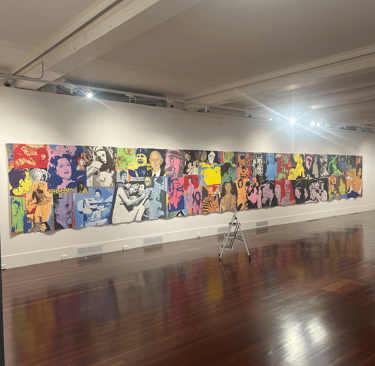 A large tapestry style Richard Larter painting installed on a batten in a gallery space