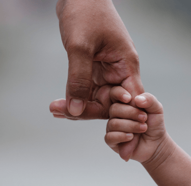 a person holding a baby's hand 