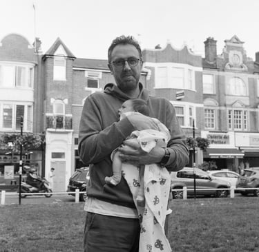 Man in London holding his newborn baby