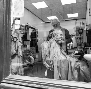 Man having his haircut at a barber shop in London