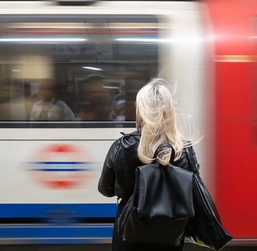 Lady waiting on the platform as her London Underground train pulls into the station