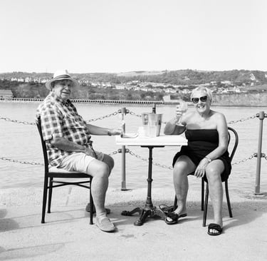 A retired couple in Folkestone enjoy some wine by the sea