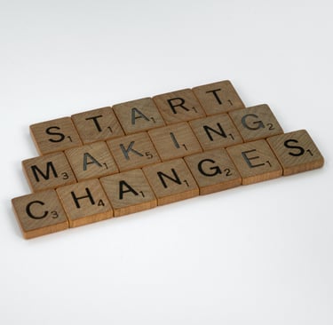 Scrabble tiles spelling out the words start making changes on a white background