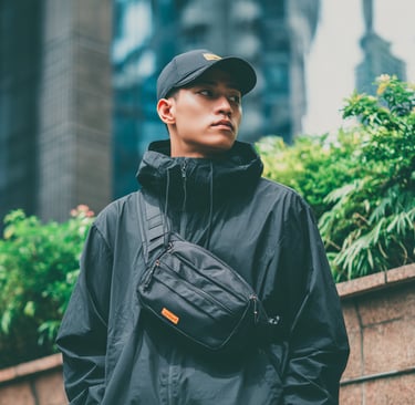 a guy with a black chest bag