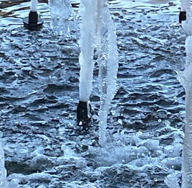 a group of water fountains with ice crystals