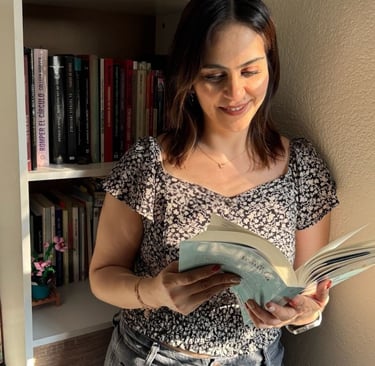 a woman is standing in front of a bookcase