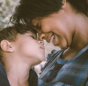 mother and young son touch noses affectionately