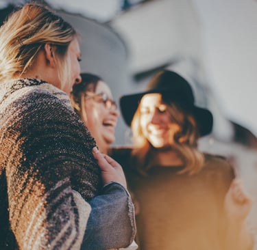 three women chat at a gathering