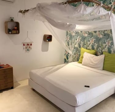 a bed with a canopy bed and a white bed