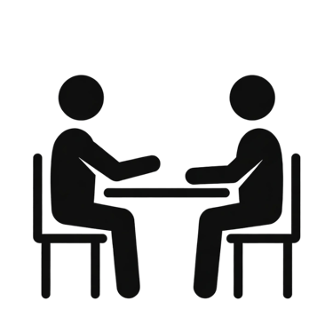 Black icon of two people sitting at a table for a job interview or business consultation.