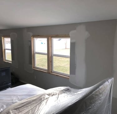 The  windows were removed and drywall has been repaired filling in the hole