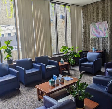 our in-person peer support group room with comfortable chairs, art, and plants