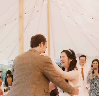 Wedding guests photographing bride and groom during their first dance