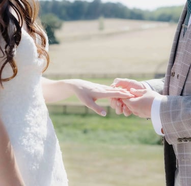Groom placing a ring onto the finger of the bride