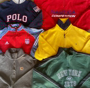 a pile of vintade branded clothes