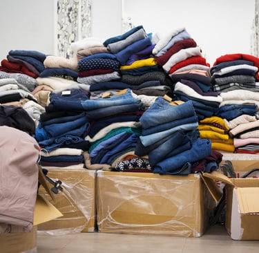 a pile of clothes and boxes of clothes