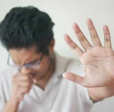 a man holding his hand up suffering from sore throat