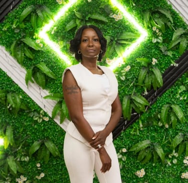 a woman in a white dress and a green wall with a green wall behind her