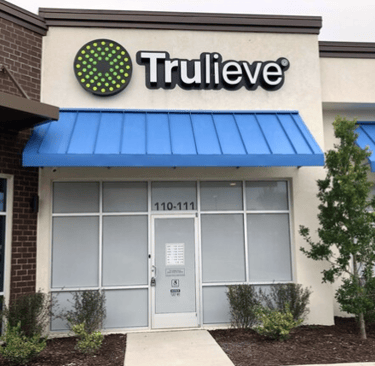 Trulieve storefront with a blue awning in Palm Coast, Florida.