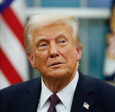 President Trump in a suit and tie with a flag