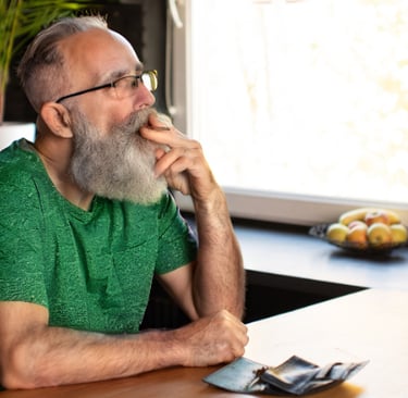 a man with a beard and glasses sitting at a table