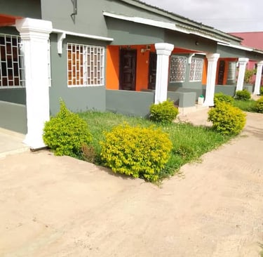 A charming view of the Kakuba Garden Hotel, featuring well-maintained guest rooms surrounded by lush