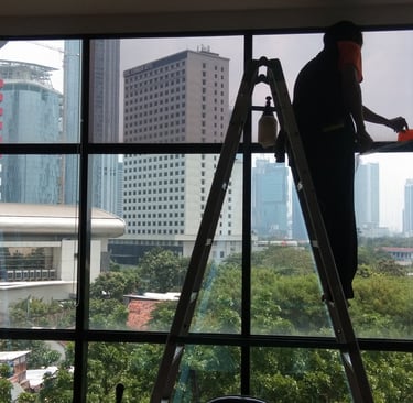 a man is standing on a ladder to get a picture of a window