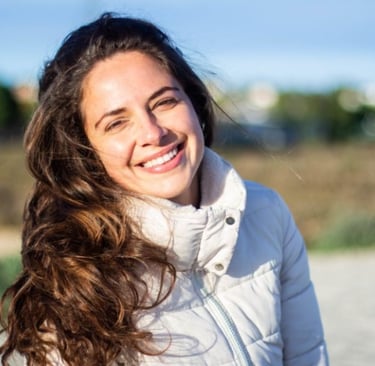 a woman with long hair and a white jacket