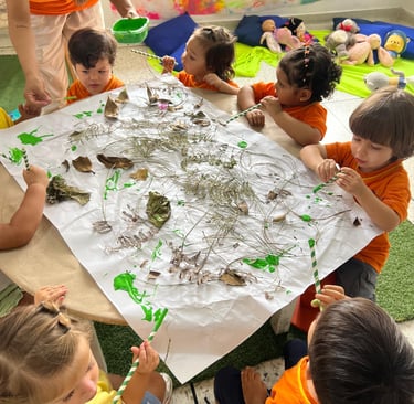 Niños creando con materiales naturales secos en jardín infantil Ukelele