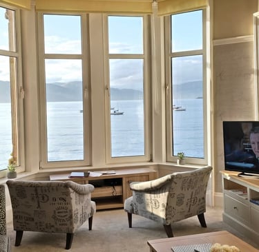 The living room at Gourock Seaview Holiday Let with a large window with sea views and a television