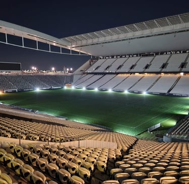 a stadium with a green field and a lot of chairs