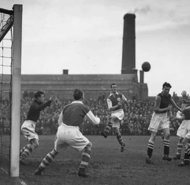 a soccer player is in the middle of a goalie