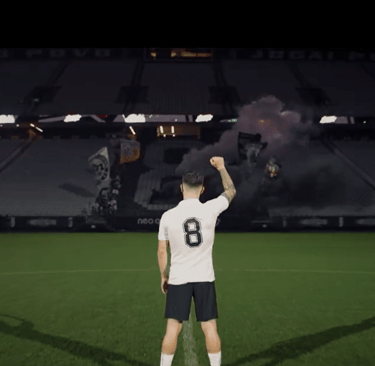 a man holding a soccer ball in front of a stadium, Rodrigo Garro