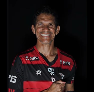 a man in a red and black shirt smiling