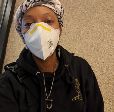 T. is wearing a mask and kufiyah. 